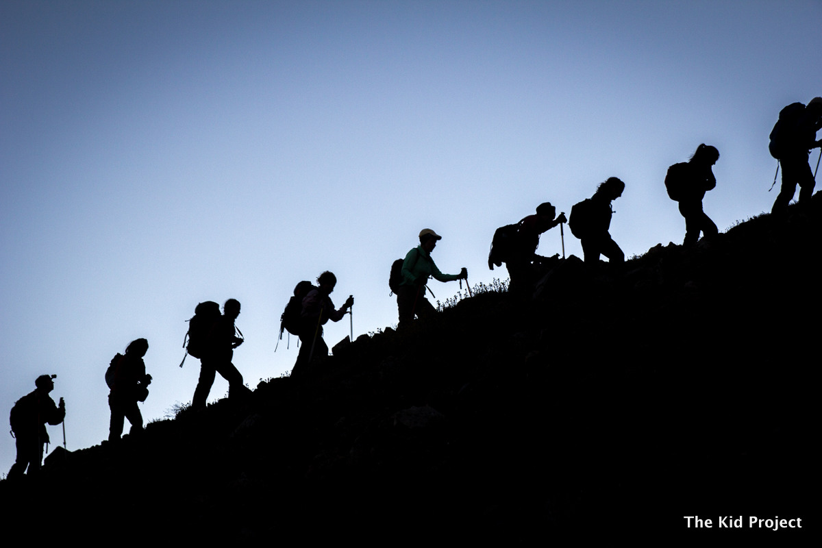 women ascending mountain