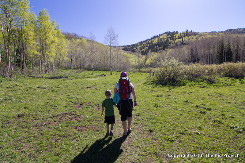 Mom and son hiking edge of lake