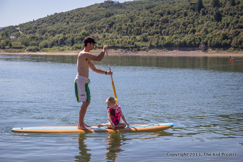 girl and dad on paddle board