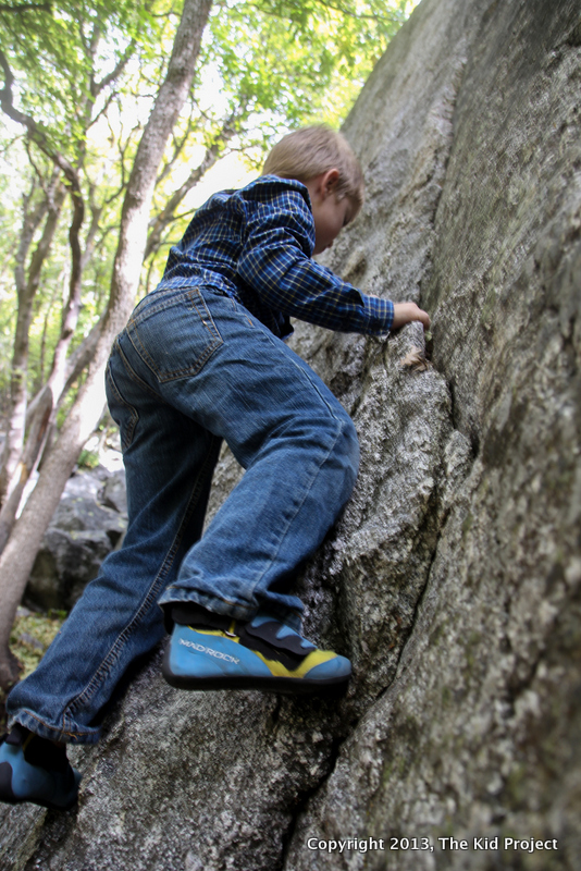 Boy bouldering , climbing