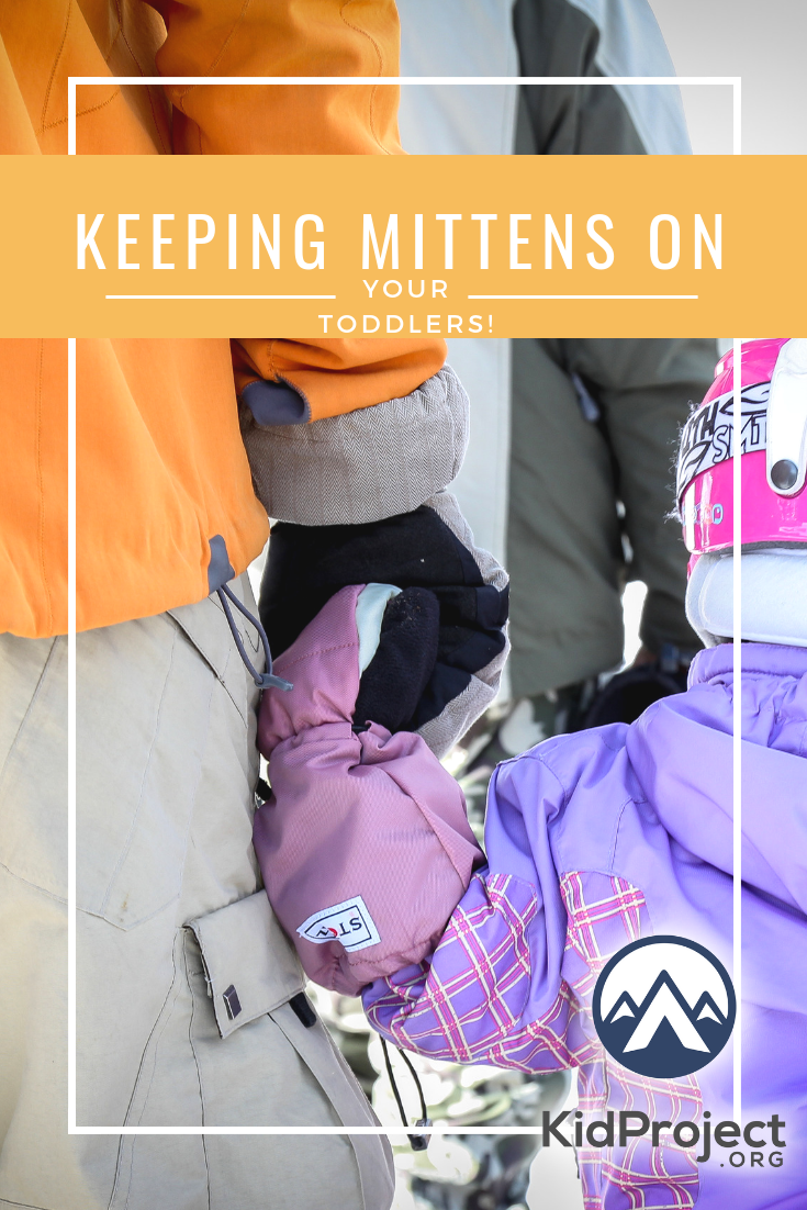 Keeping mitten on kid, snow