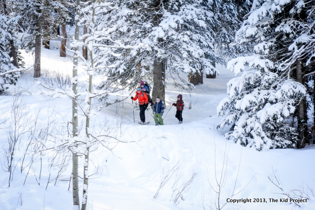 being an outdoor mom, snowshoeing through forest