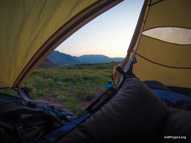 Peering out out tent while backpacking