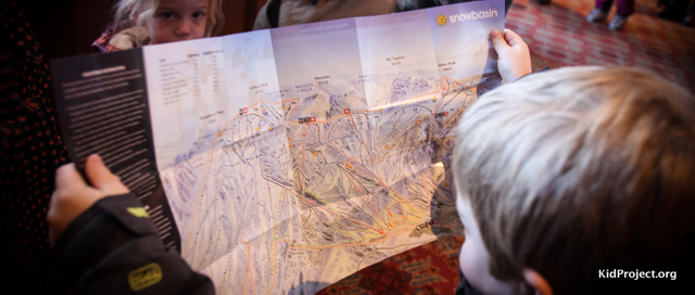 kid looking at ski area map
