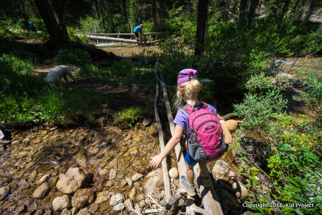 kid hiking and water crossing